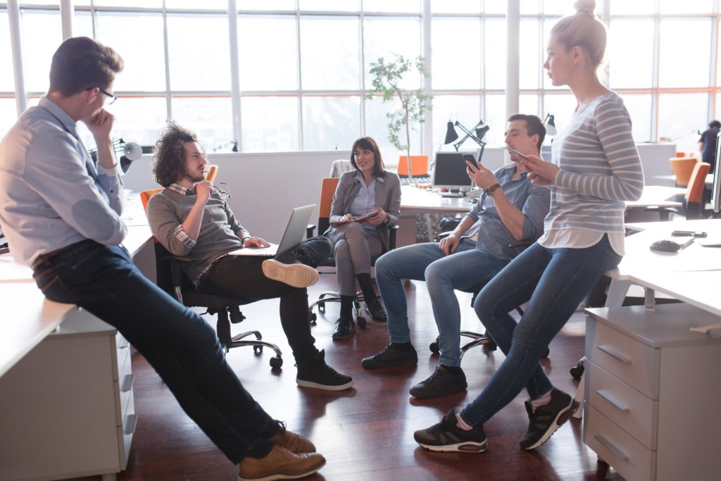 Group of a young business people discussing business plan in the office